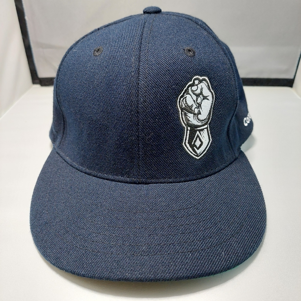 Magic headwear navy with fist design corefast snap back hat.